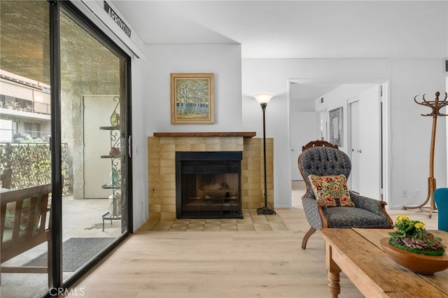 254 E Fern Ave Unit 108, Redlands, CA 92373 - sitting room featuring wood finished floors and a tiled fireplace