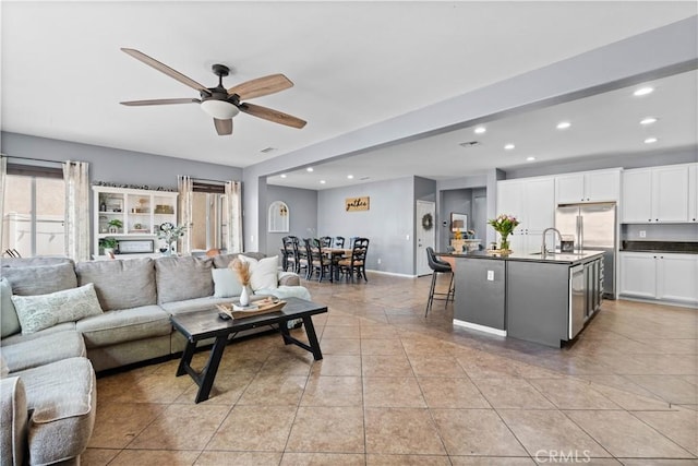 living room featuring recessed lighting, ceiling fan, and light tile patterned floors