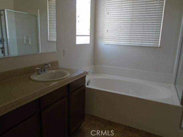 29221 Loden Cir, Menifee, CA 92584 - full bathroom featuring a shower stall, vanity, tile patterned floors, and a garden tub