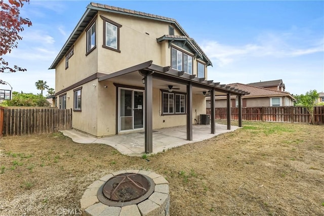 29221 Loden Cir, Menifee, CA 92584 - rear view of property with ceiling fan, an outdoor fire pit, stucco siding, and a patio