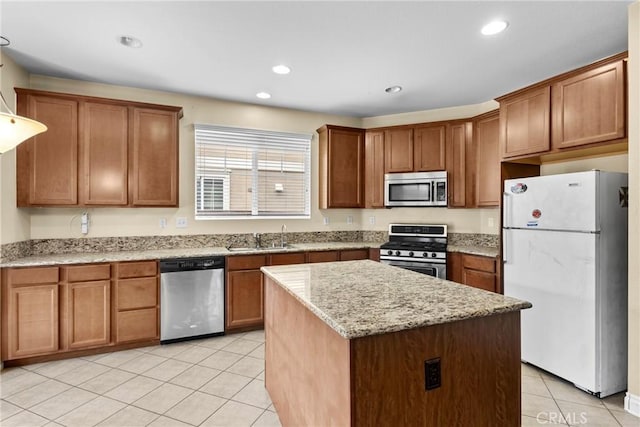 29221 Loden Cir, Menifee, CA 92584 - kitchen featuring appliances with stainless steel finishes, a sink, light tile patterned flooring, a center island, and light stone counters