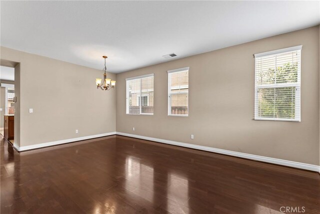 29221 Loden Cir, Menifee, CA 92584 - unfurnished room featuring a chandelier, baseboards, and dark wood-type flooring