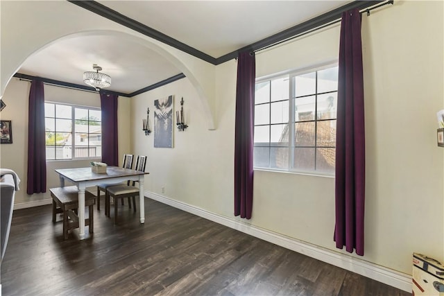 7045 Varna Ave, North Hollywood, CA 91605 - dining room with arched walkways, crown molding, dark wood-style floors, baseboards, and a chandelier