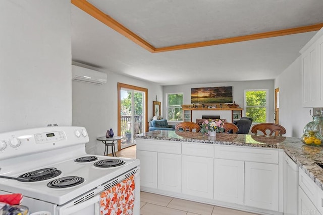2163 Gracey Ln, Fallbrook, CA 92028 - kitchen featuring white electric range, a wall mounted AC, open floor plan, white cabinets, and light stone countertops