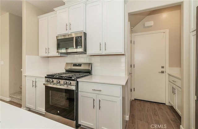 1123 Vanguard Way W, Madera, CA 93636 - kitchen with stainless steel appliances, dark wood-type flooring, light countertops, and decorative backsplash