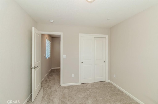 1123 Vanguard Way W, Madera, CA 93636 - unfurnished bedroom with light carpet, a closet, and baseboards