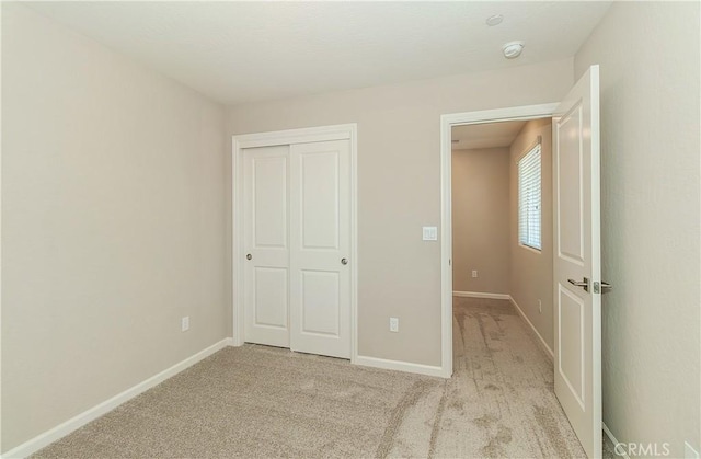 1123 Vanguard Way W, Madera, CA 93636 - unfurnished bedroom featuring baseboards, light colored carpet, and a closet