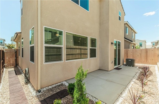 1123 Vanguard Way W, Madera, CA 93636 - view of home's exterior with stucco siding, a patio, fence, and central air condition unit
