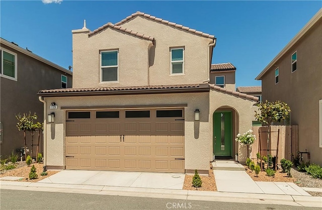 1123 Vanguard Way W, Madera, CA 93636 - view of front facade with a tile roof, stucco siding, a garage, concrete driveway, and fence