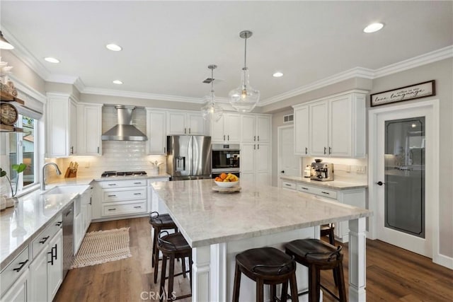 32840 Northshire Cir, Temecula, CA 92592 - kitchen featuring appliances with stainless steel finishes, wall chimney range hood, a center island, dark wood finished floors, and recessed lighting