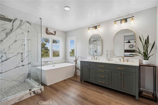 32840 Northshire Cir, Temecula, CA 92592 - full bath featuring a marble finish shower, a freestanding tub, a textured ceiling, double vanity, and wood finished floors