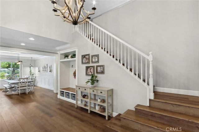 32840 Northshire Cir, Temecula, CA 92592 - staircase featuring wood finished floors, a chandelier, crown molding, a high ceiling, and recessed lighting