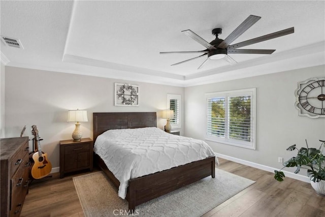 32840 Northshire Cir, Temecula, CA 92592 - bedroom featuring a tray ceiling, wood finished floors, ornamental molding, and ceiling fan