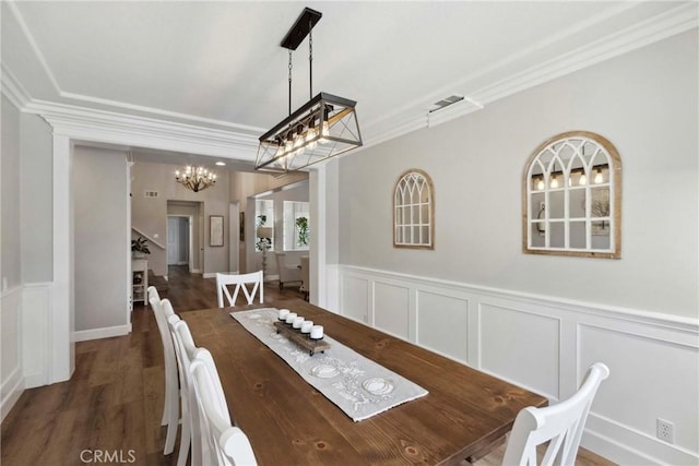 32840 Northshire Cir, Temecula, CA 92592 - dining space featuring crown molding, a chandelier, a decorative wall, wainscoting, and wood finished floors