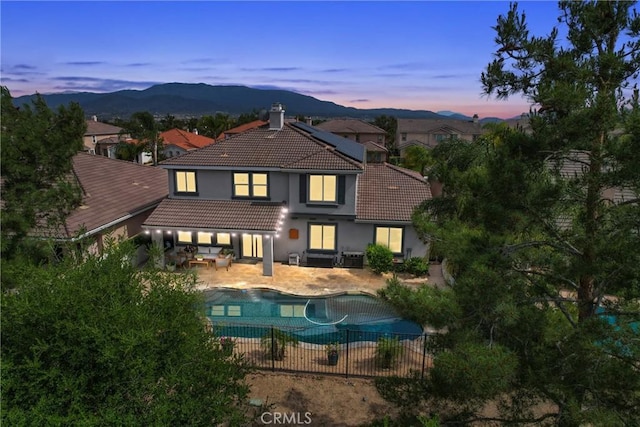 32840 Northshire Cir, Temecula, CA 92592 - back of house featuring a tile roof, an outdoor living space, stucco siding, and a patio area