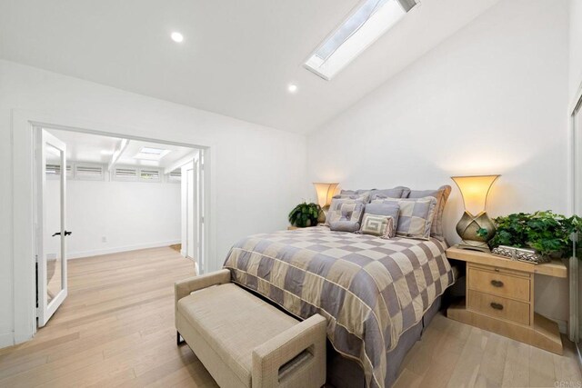 3660 Vista Campana N Unit 15, Oceanside, CA 92057 - bedroom with a skylight, light wood-style flooring, vaulted ceiling, recessed lighting, and baseboards