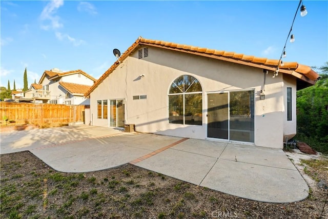 23770 Waterleaf Cir, Moreno Valley, CA 92557 - back of house featuring fence, stucco siding, a patio, and a tile roof