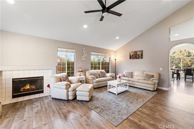 23770 Waterleaf Cir, Moreno Valley, CA 92557 - living area with wood finished floors, a ceiling fan, high vaulted ceiling, recessed lighting, and a tile fireplace