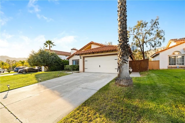 23770 Waterleaf Cir, Moreno Valley, CA 92557 - mediterranean / spanish house featuring an attached garage, a tiled roof, concrete driveway, stucco siding, and a mountain view