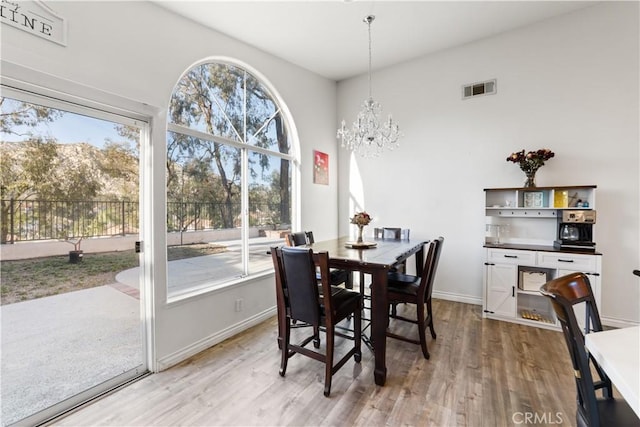 23770 Waterleaf Cir, Moreno Valley, CA 92557 - dining space featuring plenty of natural light, light wood-style flooring, a chandelier, and baseboards