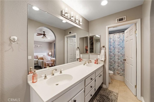 23770 Waterleaf Cir, Moreno Valley, CA 92557 - bathroom with toilet, ceiling fan, double vanity, tile patterned flooring, and ensuite bathroom