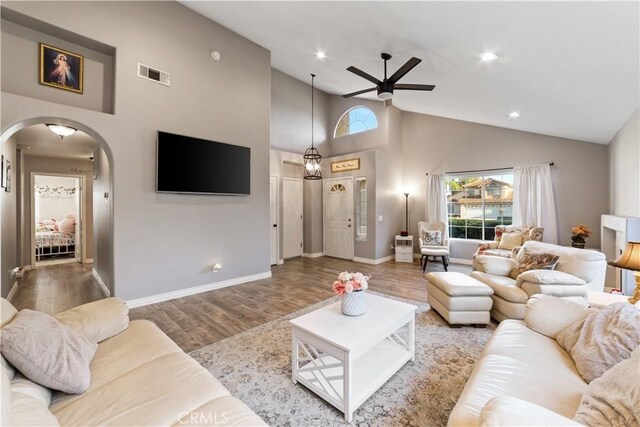 23770 Waterleaf Cir, Moreno Valley, CA 92557 - living room featuring arched walkways, healthy amount of natural light, a ceiling fan, high vaulted ceiling, and wood finished floors