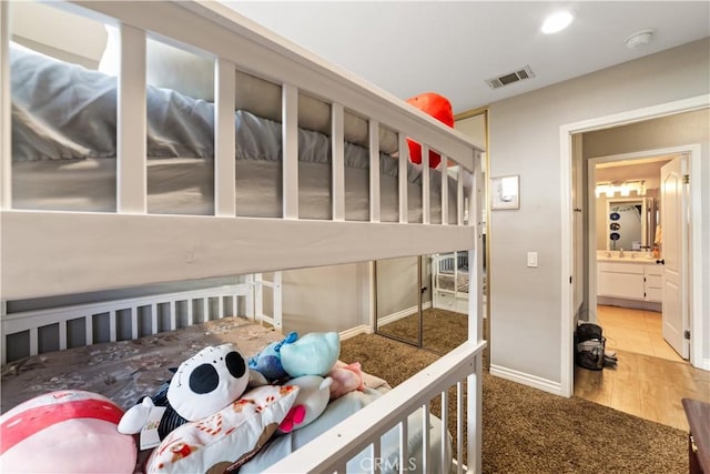 23770 Waterleaf Cir, Moreno Valley, CA 92557 - carpeted bedroom featuring a sink, wood finished floors, and baseboards