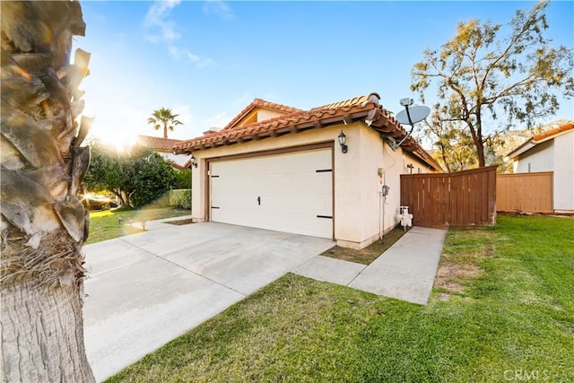 23770 Waterleaf Cir, Moreno Valley, CA 92557 - view of property exterior with a tiled roof, concrete driveway, stucco siding, an outbuilding, and an attached garage