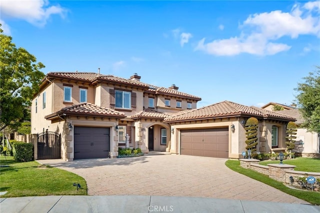 2583 N Skytop Ct, Orange, CA 92867 - mediterranean / spanish house with stucco siding, a chimney, decorative driveway, an attached garage, and a gate