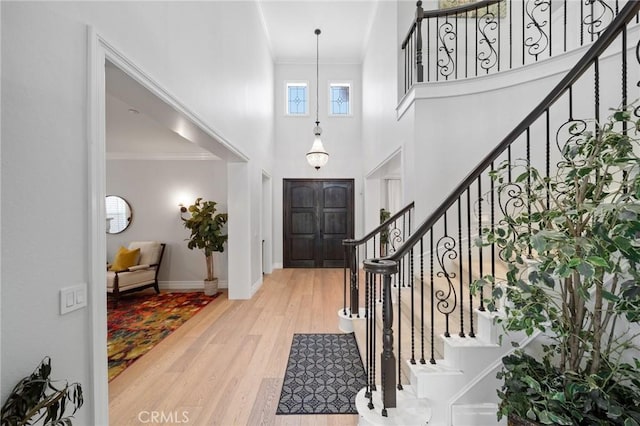 2583 N Skytop Ct, Orange, CA 92867 - foyer featuring a high ceiling, wood finished floors, crown molding, stairs, and baseboards