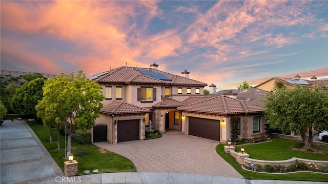 2583 N Skytop Ct, Orange, CA 92867 - mediterranean / spanish home with a garage, stucco siding, a tile roof, a lawn, and driveway