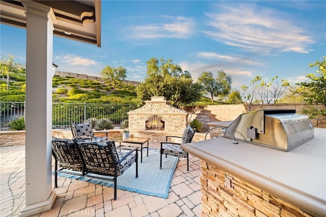 2583 N Skytop Ct, Orange, CA 92867 - view of patio featuring exterior kitchen, fence, an outdoor living space with a fireplace, and area for grilling