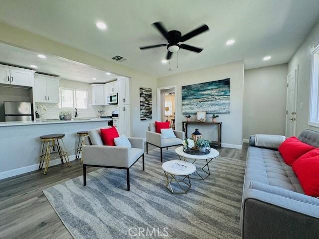 623 E Elm St, Ontario, CA 91761 - living room with light wood-style floors, recessed lighting, a ceiling fan, and baseboards