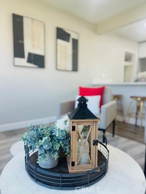 623 E Elm St, Ontario, CA 91761 - detailed view of wood finished floors, baseboards, and beamed ceiling