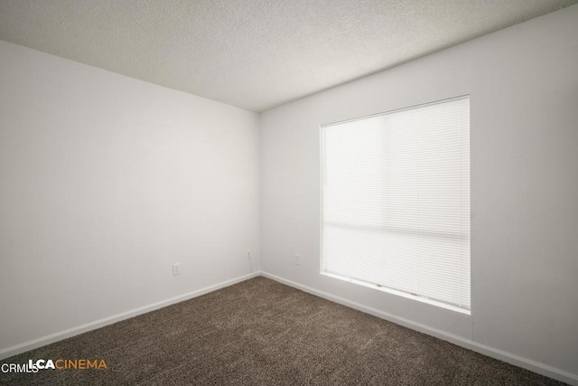2617 Pinon Spring Cir Unit C, Bakersfield, CA 93309 - spare room featuring dark colored carpet, baseboards, plenty of natural light, and a textured ceiling