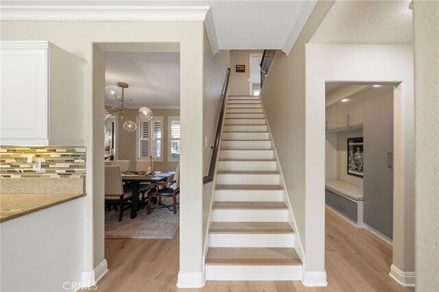 46397 Kohinoor Way, Temecula, CA 92592 - stairway featuring wood finished floors and ornamental molding