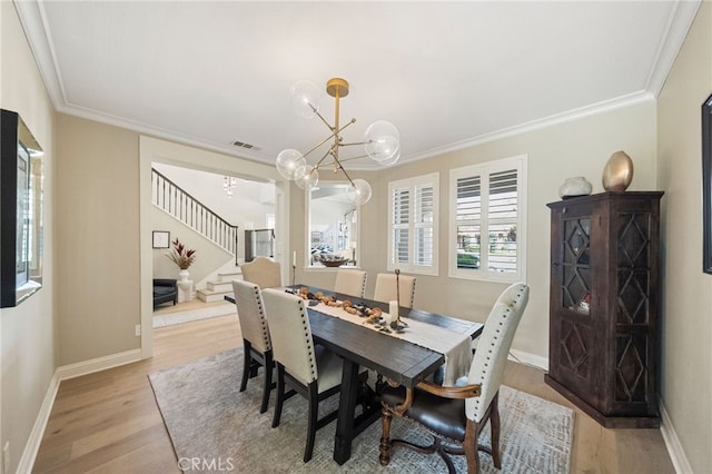 46397 Kohinoor Way, Temecula, CA 92592 - dining space with a chandelier, stairway, crown molding, and light wood-type flooring