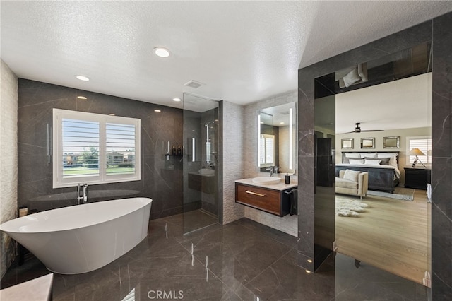 46397 Kohinoor Way, Temecula, CA 92592 - full bath with a freestanding bath, vanity, a textured ceiling, a walk in shower, and a ceiling fan