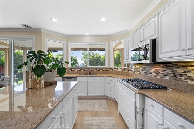 46397 Kohinoor Way, Temecula, CA 92592 - kitchen with stainless steel appliances, light wood finished floors, white cabinets, recessed lighting, and crown molding