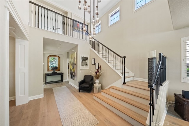 46397 Kohinoor Way, Temecula, CA 92592 - entrance foyer featuring wood finished floors, stairs, a high ceiling, and a chandelier