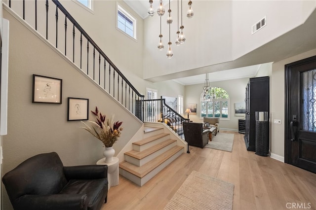 46397 Kohinoor Way, Temecula, CA 92592 - foyer with a chandelier, a towering ceiling, stairway, healthy amount of natural light, and light wood finished floors