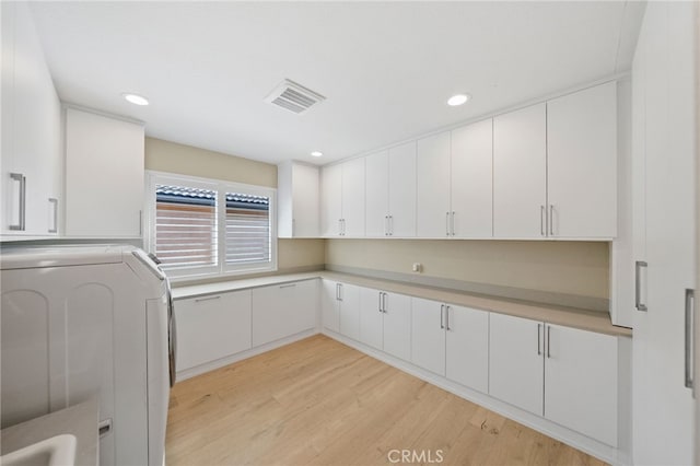 46397 Kohinoor Way, Temecula, CA 92592 - laundry area with washer / dryer, cabinet space, light wood finished floors, and recessed lighting