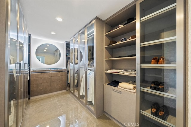 46397 Kohinoor Way, Temecula, CA 92592 - washroom featuring recessed lighting, built in shelves, and estacked washer and dryer