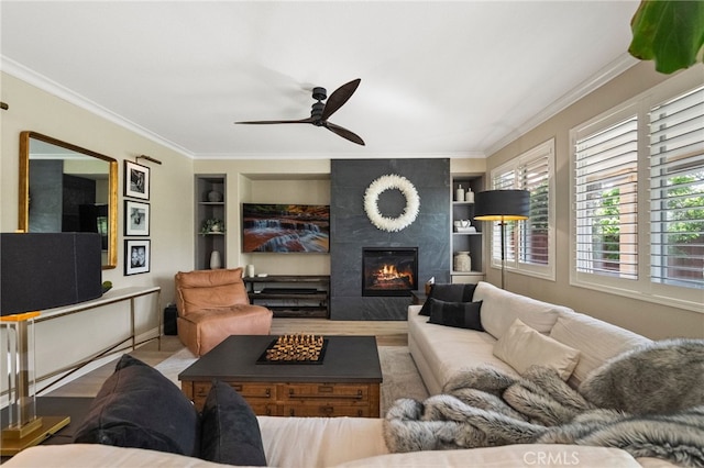 46397 Kohinoor Way, Temecula, CA 92592 - living area with built in features, a ceiling fan, ornamental molding, and a tile fireplace