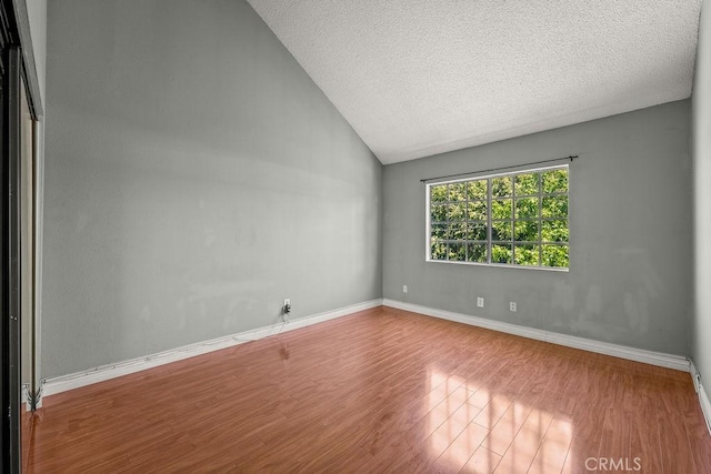 628 Daisy Ave Unit 420, Long Beach, CA 90802 - spare room featuring wood finished floors, lofted ceiling, baseboards, and a textured ceiling