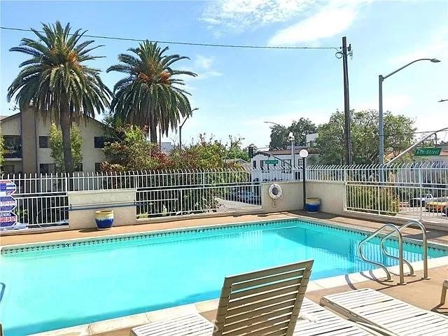 628 Daisy Ave Unit 420, Long Beach, CA 90802 - community pool with fence and a patio area