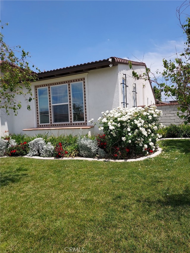 4511 S Luna Privado, Ontario, CA 91761 - view of home's exterior with stucco siding and a lawn