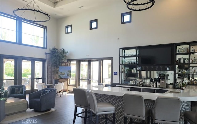 4511 S Luna Privado, Ontario, CA 91761 - indoor wet bar featuring french doors, hardwood / wood-style floors, a high ceiling, and a chandelier