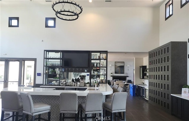 4511 S Luna Privado, Ontario, CA 91761 - community bar area with a towering ceiling, dark wood-style floors, and a chandelier