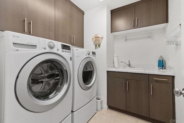 4304 Pacifica Way Unit 2, Oceanside, CA 92056 - laundry area with washer and dryer, cabinet space, and light tile patterned floors